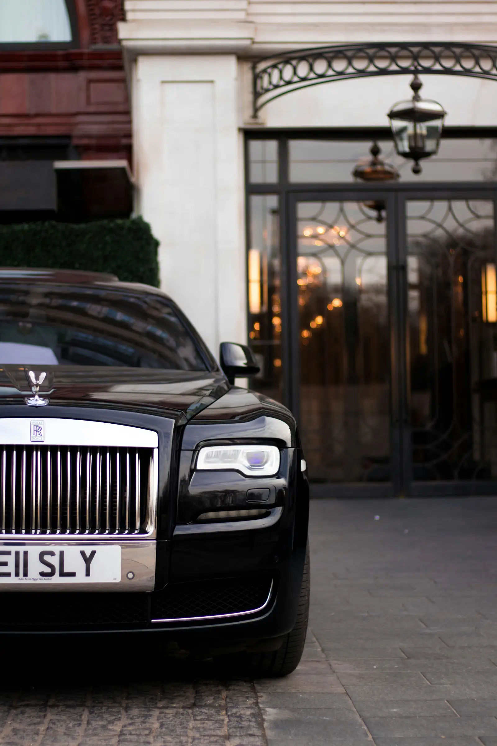 Rolls Royce car parked in front of a luxury hotel